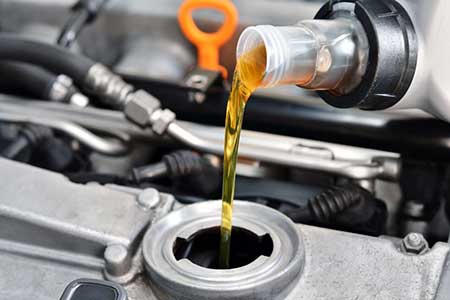Pouring oil in to a car's engine